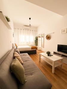a living room with a couch and a bed at Genesis-Loft San Enrique 20 in Madrid