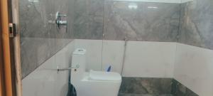 a small bathroom with a toilet and a shower at V Land Homestay in Vagamon +7 photos