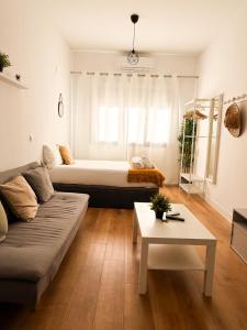a living room with a bed and a couch at Genesis-Loft San Enrique 20 in Madrid