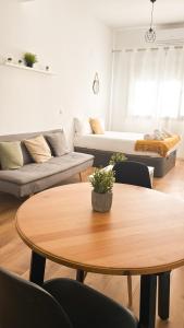 a living room with a table and a couch at Genesis-Loft San Enrique 20 in Madrid +19 photos