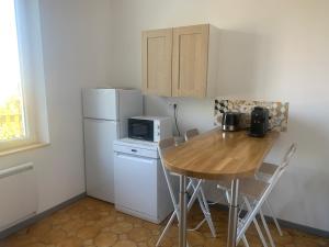 a small kitchen with a table and a refrigerator at Val et Mer House in Ault +15 photos