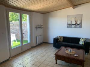a living room with a couch and a table at Val et Mer House in Ault
