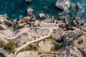 an aerial view of a road on a mountain next to the ocean at CONTiNUUM in Ulcinj +52 photos