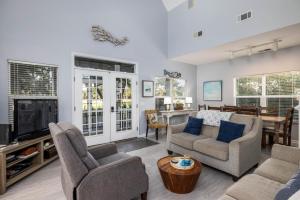 een woonkamer met een bank, stoelen en een tv bij 33 Davis Love in Fripp Island