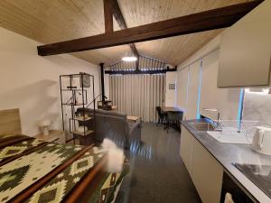 a kitchen with a counter and a dining room at Quinta da Portela in Ferro