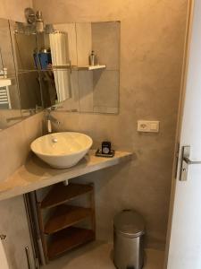 a bathroom with a sink and a mirror at Studio Saint-Tropez Heraclée in Saint-Tropez