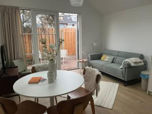 a living room with a table and a couch at Ons Bijhuis in Wijk aan Zee