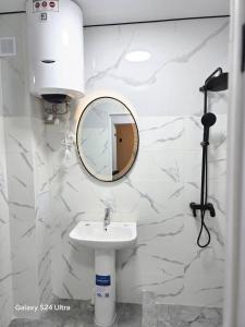 a bathroom with a sink and a mirror at NovaMotel in Karakol +29 photos