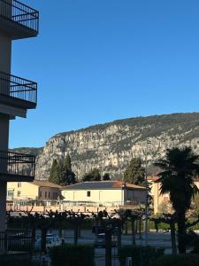 a view of a building with a mountain in the background at Colombo Central Apartment in Garda