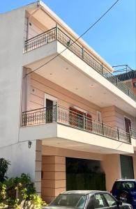 a house with a car parked in front of it at Nea Peramos Apartment-2 in Nea Peramos +8 photos