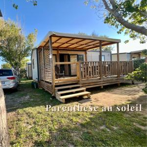 a large wooden cabin with a porch and a deck at MobilHomeTorreilles in Torreilles