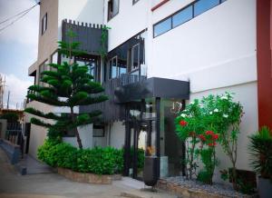 a building with plants on the side of it at Sylz Residence Studio in Accra