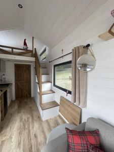 a living room of a tiny house with a window at Na samote u Noemi in Komjatná