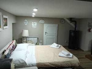 a bedroom with a bed with two towels on it at Al Cottage in Oliveto Lario +22 photos