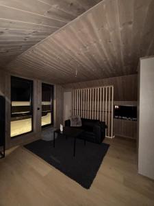 a living room with a couch and a table at Exclusive Cabin with Sauna in Fossmo
