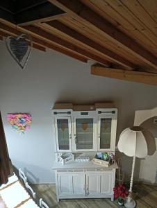 a room with a white cabinet with stained glass windows at Al Cottage in Oliveto Lario