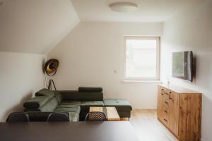 a living room with a couch and a table at Prázdninový dům Sobotín in Sobotín
