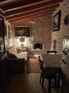 a living room with a couch and a table at Casa tipica sarda in Gonnosnò