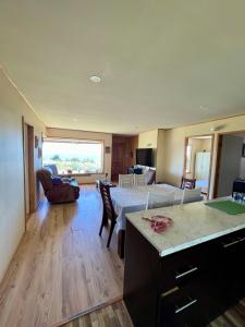 a large living room with a bed and a living room at Casa con acceso directo al lago y hermosas vistas in Puerto Varas