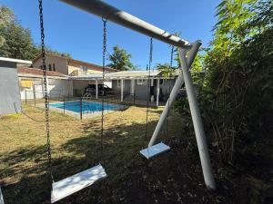 an empty swing set in front of a house at Casa en el centro de Licanray in Licán Ray