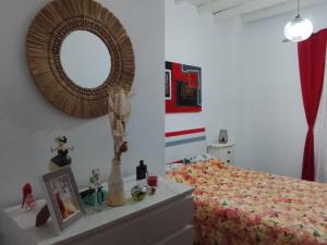 a bedroom with a bed and a mirror on the wall at Casa Atelier Designer Moda Sandra Silva in Alpalhão