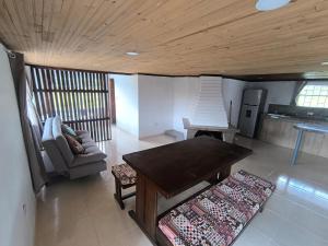 a living room with a table and a couch at Cabaña El Laurel in Pasto +19 photos
