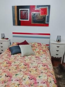 a bedroom with a bed with a colorful blanket at Casa Atelier Designer Moda Sandra Silva in Alpalhão