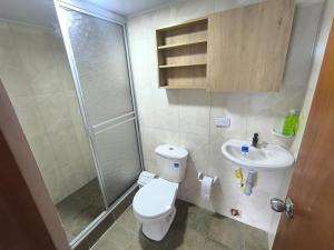 a bathroom with a shower and a toilet and a sink at Cabaña El Laurel in Pasto