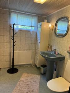 a small bathroom with a sink and a toilet at Kungsskogen Kolmården in Kolmården +12 photos