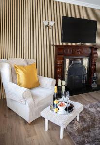 a living room with a couch and a fireplace with a television at Katies Cottage in Gortaclare