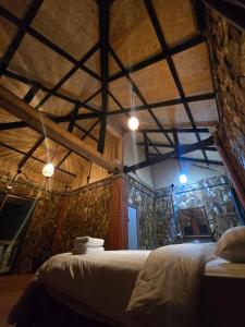 a bedroom with a bed in a room with a stone wall at Pirates Bay Resort & Spa in Ko Lanta