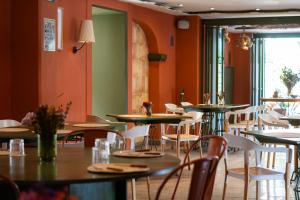 a row of tables and chairs in a restaurant at Flor de Mayo Hotel & Restaurant in Cuernavaca