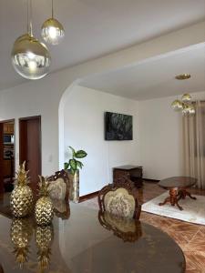 a living room with a glass table and chairs at Casa estrelicia II in Relógio do Poiso
