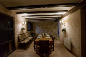a dining room with a table and a couch at La Casa del Bosque in Cabra de Mora