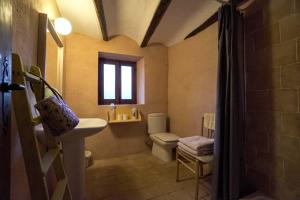 a bathroom with a sink and a toilet and a window at La Casa del Bosque in Cabra de Mora +56 photos