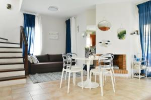 a living room with a table and chairs at Oikos in Hanioti