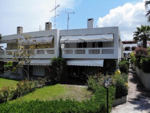 a large white building with a yard in front of it at Oikos in Hanioti