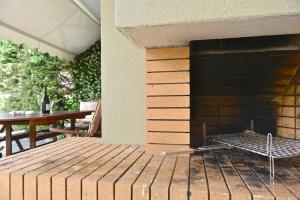 an outdoor patio with a grill and a table at Oikos in Hanioti