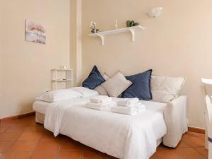 a bedroom with a white bed and a couch at Paradise Apartment, Comfort e Private Parking in Prato +7 photos