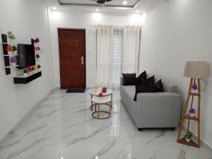 a living room with a couch and a table at EVA Residency in Kallar