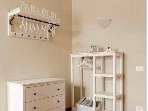a room with a white dresser and a shelf at Paradise Apartment, Comfort e Private Parking in Prato