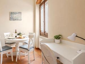 a white dining room with a white table and a white chair at Paradise Apartment, Comfort e Private Parking in Prato