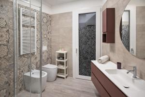 a bathroom with a toilet and a sink and a shower at QUEEN HOME Luana in Venice +48 photos