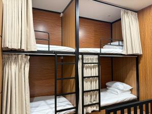 a bunk room with three bunk beds in it at Peanut Stay Hostel in Hanoi