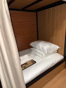 a bunk bed with white sheets and pillows at Peanut Stay Hostel in Hanoi