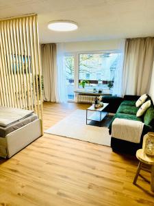 a living room with a couch and a bed in it at MOLA Apartments-Ruhrnahes Apartment mit Balkon & Parkplatz im Herzen von Schwerte-4P in Schwerte