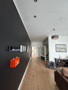 a living room with a black wall and wooden floors at DoubleRoom in shared apartment 2nd floor in Linz am Rhein