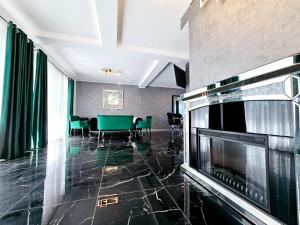 a living room with a table and a fireplace at Luxury Private Villa in Tunari