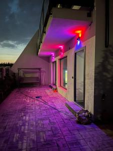 a room with purple lights on the side of a building at Luxury Private Villa in Tunari