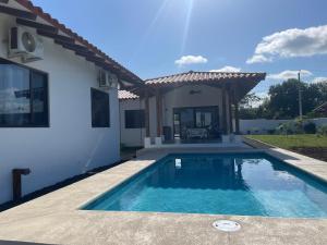 a swimming pool in front of a house at Farmer's house in El Quije